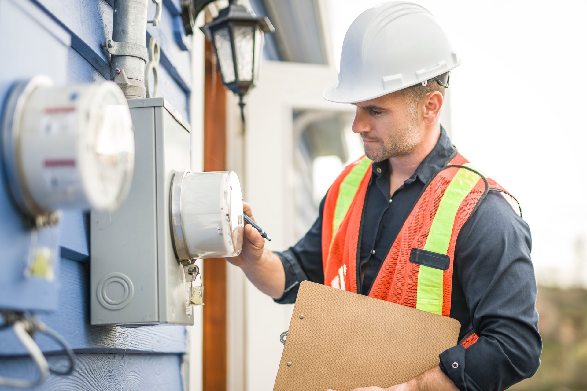 man with hard hat standing in front of a electric meter socket