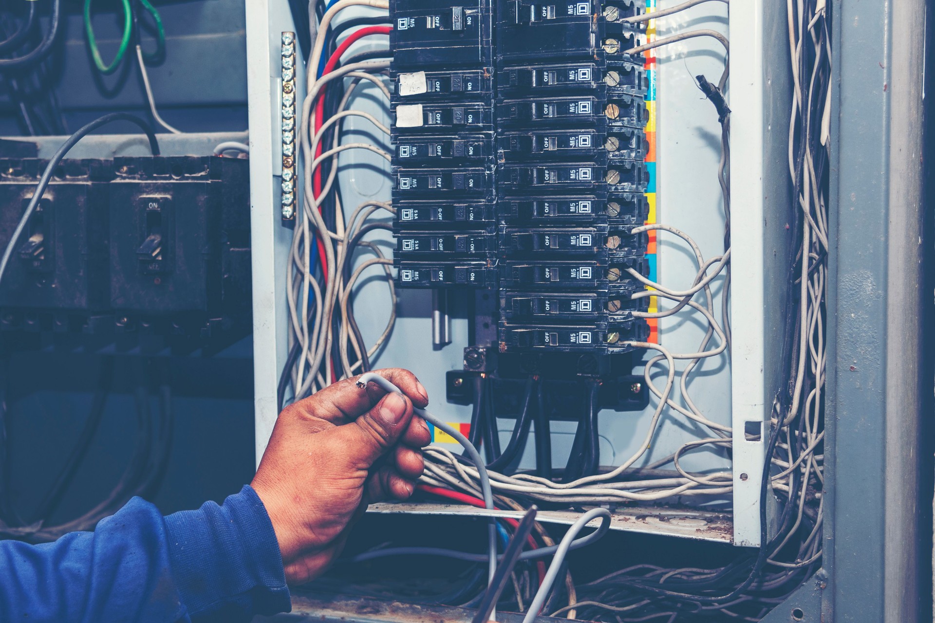 Master Electrician mechanic technician checking wire electric cabinet. Inspector men hands working switchboard machinery maintenance service. Electrician circuit repair voltage operation. Men hands fix breaker
